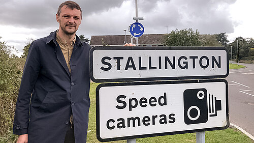 Councillor Alec Sandiford standing next to the "Stallington" sign